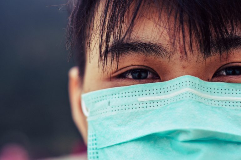close up of asian male wearing doctor mask