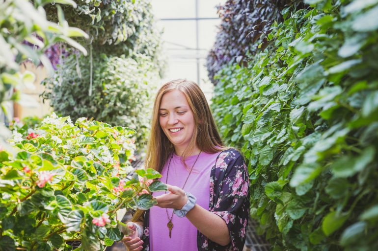 happy young woman smiling in green garden